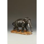 A JAPANESE BRONZE ELEPHANT, the animal gently stepping forward and with its' head raised slightly