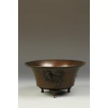 A JAPANESE BRONZE FLARED BOWL, the exterior finely decorated in relief with a quirin, a ho ho