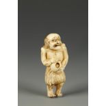 A JAPANESE IVORY NETSUKE OF A FISHERMAN, the emaciated figure with an alarmed expression and holding