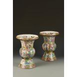 A PAIR OF CHINESE FAMILLE ROSE GU VASES, each decorated with three continuous registers of figures