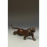 A JAPANESE BRONZE TIGER, the animal crouched low and striding forward with its' head raised to the