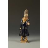 A CHINESE GLAZED POTTERY OFFICIAL, the figure wearing a tall hat and robes with a deep-blue glaze,