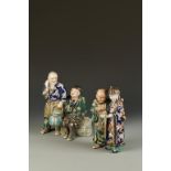 TWO JAPANESE IMARI FIGURE GROUPS, one showing two friendly scholars reading a scroll, the other with