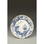 A JAPANESE ARITA BLUE AND WHITE FOLIATE DISH decorated with birds and flowers in garden settings,