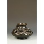 A LARGE JAPANESE BRONZE SQUAT VASE, the compressed spherical body decorated on one side with flowers