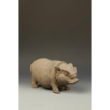 A MAJAPAHIT TERRACOTTA WILD BOAR MONEY BANK, the creature with incised facial features and wearing a