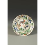 A CHINESE FAMILLE VERTE SAUCER DISH of foliated form, the centre decorated with a kylin and phoenix,