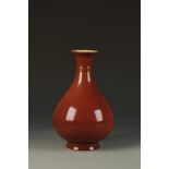 A CHINESE COPPER-RED PEAR-SHAPED VASE, the gently rounded body evenly covered in a rich glaze of