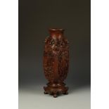 A LARGE CHINESE CARVED WOOD VASE of squared form, the shoulder carved with mythical creatures