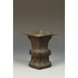 A CHINESE ARCHAISTIC BRONZE GU VASE of compressed square form, decorated in low relief with