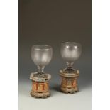 AN UNUSUAL PAIR OF CHINESE PARCEL-GILT OCTAGONAL STANDS, and associated English glass rummers, the