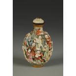 A CHINESE FAMILLE ROSE 'LUOHANS' SNUFF BOTTLE of ovoid form, the body decorated in high relief