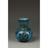 A PERSIAN TURQUOISE-GLAZED VASE, the body of rounded form beneath a flared neck, decorated in dark