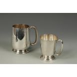 A PINT MUG of tapering circular form with "C"-shaped handle, on a spreading circular foot,