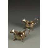 A PAIR OF SAUCEBOATS of shaped oval form with leaf-capped scroll handles and gadrooned borders, on