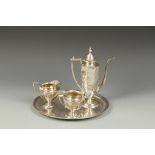 A FOUR PIECE TEA SET of elongated octagonal form, with angular handles, monogrammed, three pieces