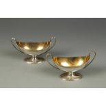 A PAIR OF GEORGE III SALTS of boat form, with beaded loop handles and reeded borders, with gilt