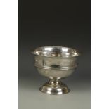 A PUNCH BOWL of tapering circular form with central reeded girdle, on a spreading circular foot,