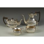 AN EDWARDIAN FOUR PIECE TEA/COFFEE SET of shaped rectangular form with angular handles, some