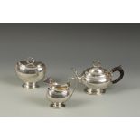 A DUTCH THREE PIECE TEA SET of oval form with wirework serpent finials, scroll handles, reeded