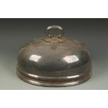 A 19TH CENTURY MEAT DISH COVER of oval form with loop handle, engraved with a crest, 20" long