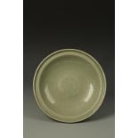 A CHINESE LONGQUAN CELADON DISH with a central moulded flower motif within a ribbed cavetto, Yuan/