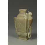 A CHINESE GREEN JADE MINIATURE WATER DROPPER in the form of a vase, late Qing, 4" high