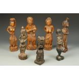 A GROUP OF SEVEN SOUTHEAST ASIAN CARVED WOOD FIGURES, 19th/20th century, 9.5" to 13"; and a