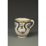 A WORCESTER PORCELAIN COFFEE CUP, with entwined handle, painted in Sevres style with flowers