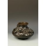 A JAPANESE BRONZE SQUAT VASE decorated in relief with flowers, signed, Meiji, 12" dia.