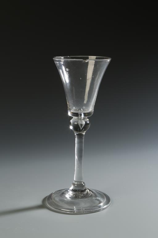 A GEORGE III WINE GLASS with flared bowl and turned over foot rim, 6.5"