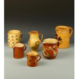 A COLLECTION OF SLIPWARE JUGS, including a Mannheim example, decorated with a bird, 8.5" to 4.25" (