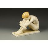 HERTWIG KATZHUTTE: A MATT GLAZED FIGURE OF A NUDE, seated with her knees up, on a rectangular