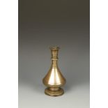AN INSCRIBED BRASS FLASK, possibly North African, with a faceted body, circa 17th/18thC, 8.5" high