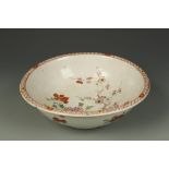 A CHINESE FAMILLE ROSE BASIN decorated with flowers amongst rocks, Qing, 18thC, 10.75" dia.