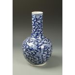 A CHINESE BLUE AND WHITE BOTTLE VASE decorated with two dragons, Kangxi mark, 19thC, 14" high