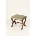 A VICTORIAN MAHOGANY DRESSING STOOL with upholstered seat, on carved "X"-frame support, 19" wide