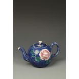A STAFFORDSHIRE SALT-GLAZED STONEWARE TEAPOT AND COVER with moulded spout and boldly painted with