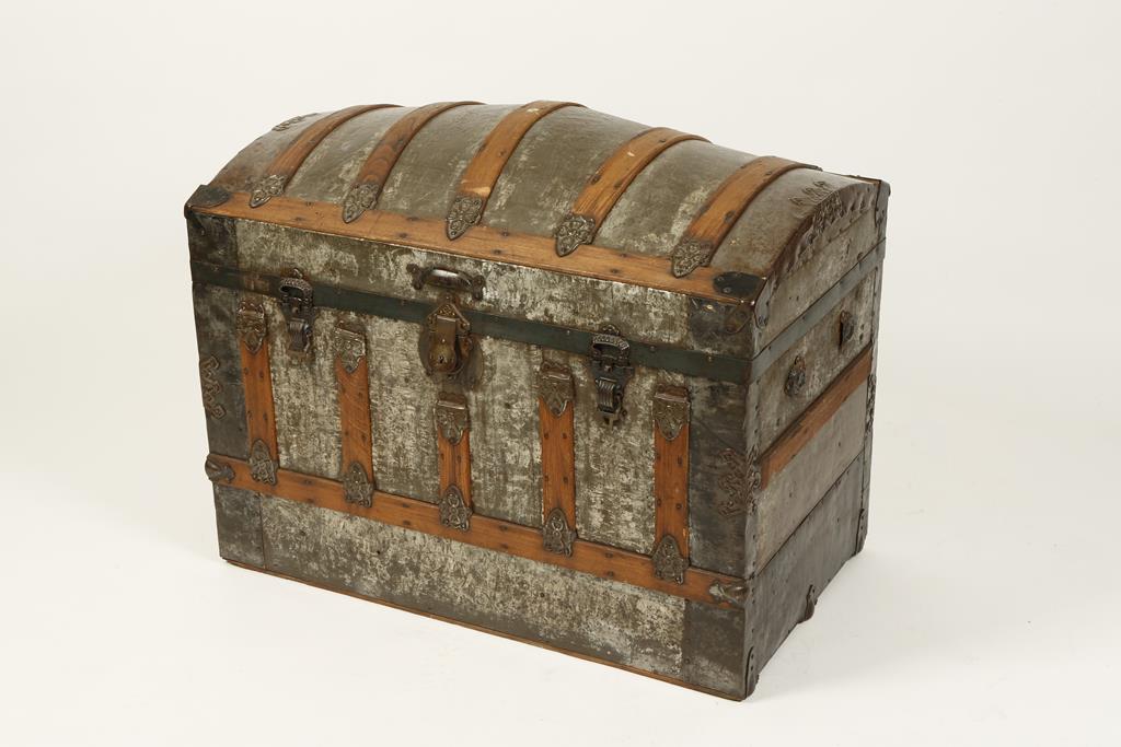 A DOME-TOP TRAVELLING TRUNK with metal fittings, 35" wide