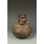 AN AFRICAN LUBA STYLE WOOD VESSEL, the top carved as a human head, 9" high
