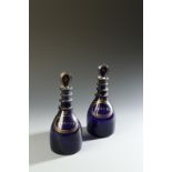 A PAIR OF GEORGE III 'BRISTOL' BLUE DECANTERS, with gilt 'Brandy' and 'Shrub' labels, 9" high (2)