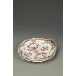 A WORCESTER PORCELAIN 'BLIND EARL' DISH, with a moulded rosebud and stork handle, painted in puce