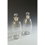 TWO EARLY 19TH CENTURY DECANTERS, with painted 'Brandy' and 'Rum' labels, 8" high