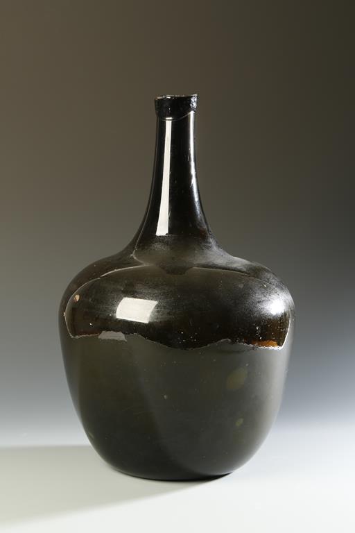 A LARGE GLASS BOTTLE, with narrow neck and 'kicked in' base, possibly 18th century, 15" high. See