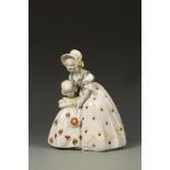 KATZHUTTE: AN EARTHENWARE GROUP OF A MOTHER AND CHILD painted in puce and yellow on a circular base,