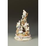 PARIS PORCELAIN: A TABLE CENTREPIECE MODELLED AS A TREE STUMP, surrounded by 18th century style