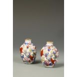 A PAIR CHINESE FAMILLE ROSE SNUFF BOTTLES, modelled in relief, Qianlong marks, late Qing/Republic,