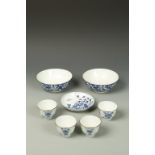 A GROUP OF SEVEN CHINESE BLUE AND WHITE WARES: a saucer dish, four wine cups, and two bowls; Qing,