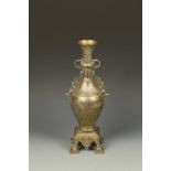 AN ISLAMIC METALWORK VASE, with foliate and calligraphic decoration on a square base, 13.25" high