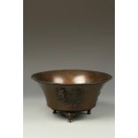 A JAPANESE BRONZE FLARED BOWL decorated in relief with a kirin and ho ho bird, signed Shokaken,